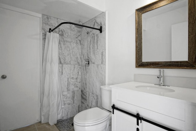 bathroom with toilet, tile patterned floors, a shower stall, and vanity