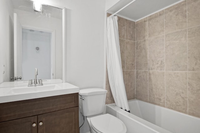 full bath with toilet, shower / bath combo with shower curtain, and vanity