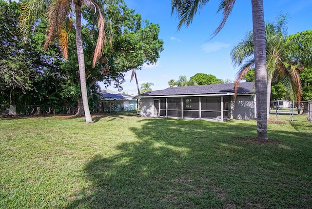 view of yard featuring a sunroom and fence