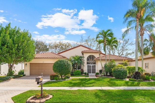 mediterranean / spanish-style home with a garage, a tile roof, decorative driveway, and stucco siding