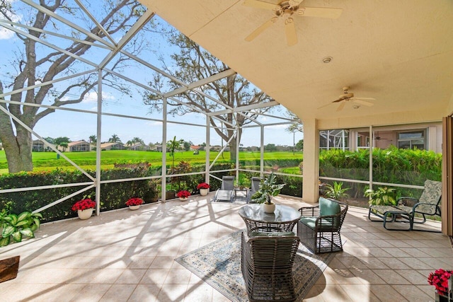 unfurnished sunroom featuring ceiling fan