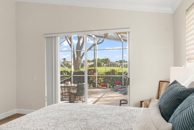 bedroom with baseboards, access to outside, wood finished floors, and crown molding