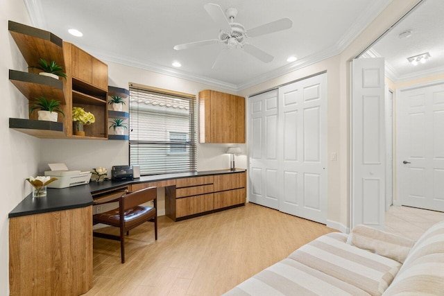 office space featuring ceiling fan, recessed lighting, light wood-type flooring, built in desk, and crown molding