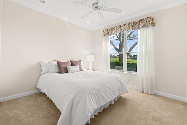 bedroom featuring ornamental molding, light colored carpet, and baseboards