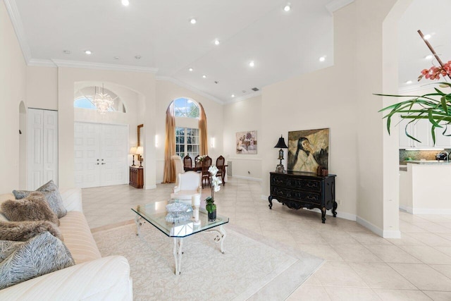 living room featuring arched walkways, high vaulted ceiling, light tile patterned floors, baseboards, and crown molding