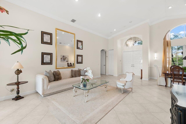 living room featuring arched walkways, ornamental molding, light tile patterned flooring, and baseboards