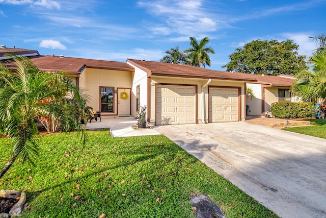 view of front of house featuring a garage, a front yard, concrete driveway, and stucco siding