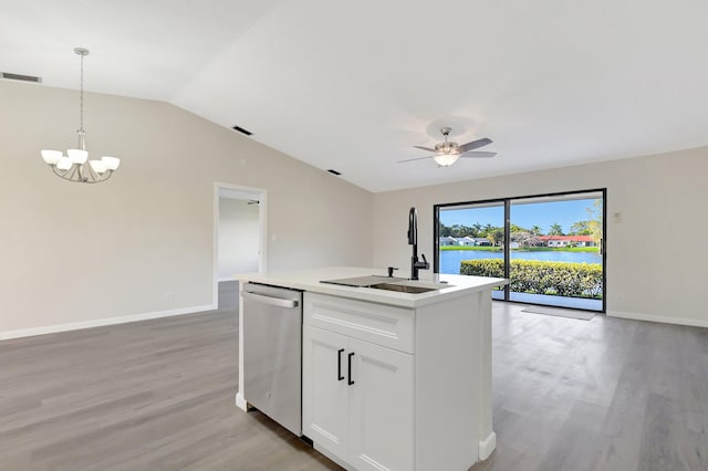 kitchen featuring a water view, hanging light fixtures, stainless steel dishwasher, open floor plan, and white cabinetry