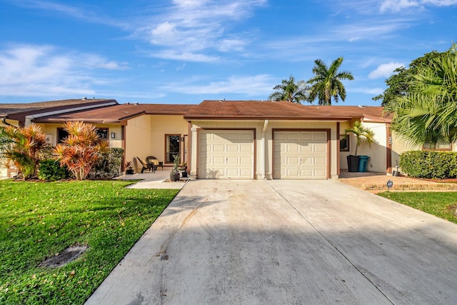 ranch-style home featuring a garage, driveway, a front yard, and stucco siding