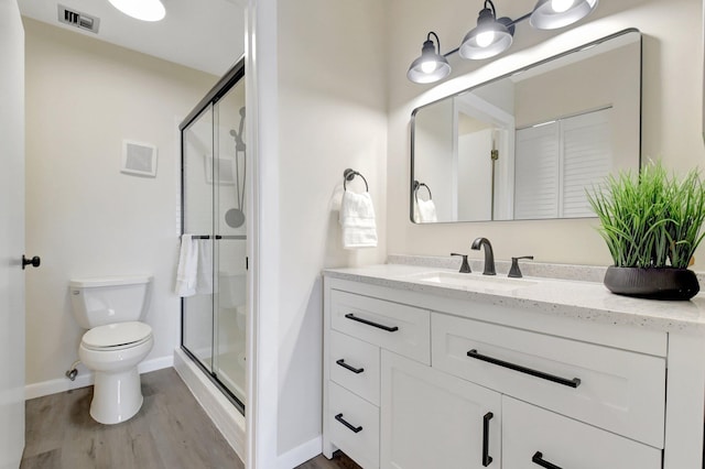 bathroom featuring a stall shower, vanity, and visible vents