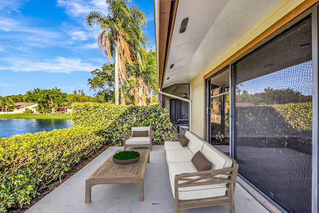 view of patio / terrace with a water view and an outdoor living space