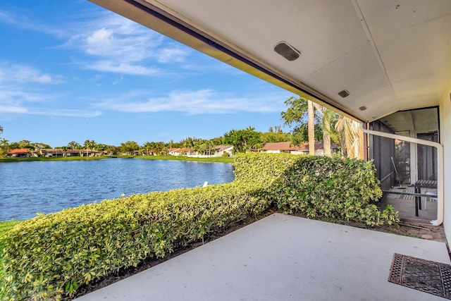 view of patio / terrace featuring a sunroom and a water view