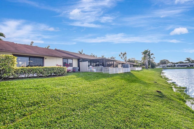 view of yard featuring a water view and fence