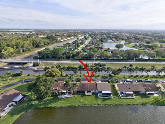 drone / aerial view with a water view and a residential view