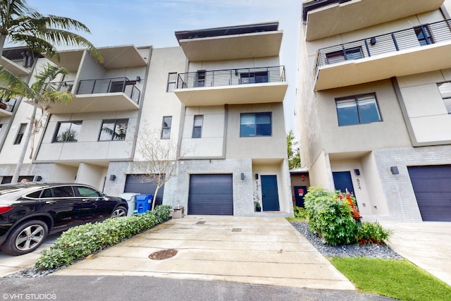 view of property featuring driveway and an attached garage