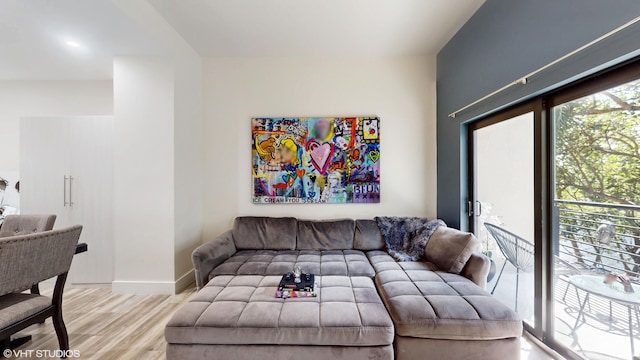 living room featuring baseboards and wood finished floors