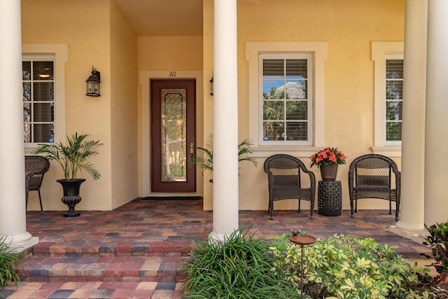 entrance to property with stucco siding