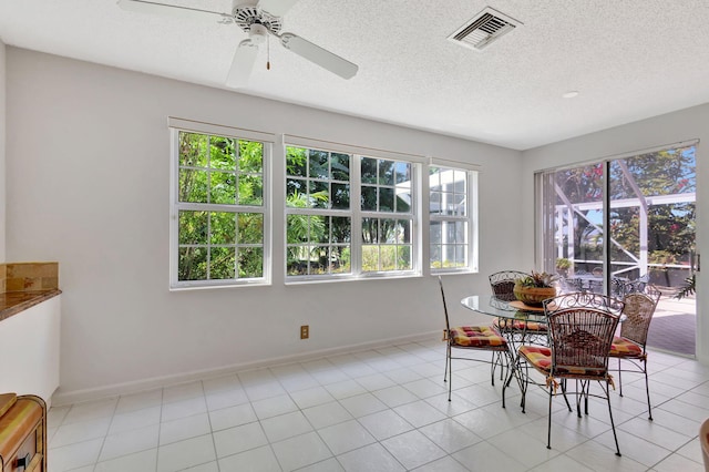 dining area with plenty of natural light, visible vents, and baseboards