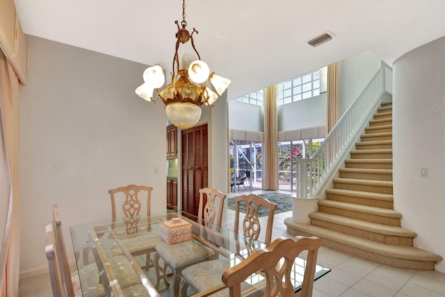 dining space with stairs, light tile patterned floors, visible vents, and an inviting chandelier