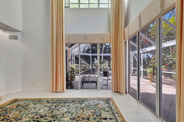 doorway to outside with a sunroom and tile patterned floors