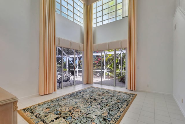 interior space with a towering ceiling and baseboards