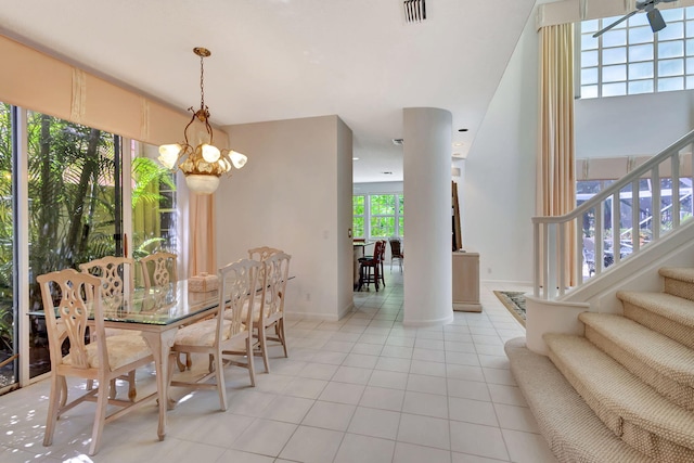 dining area featuring visible vents, stairway, and light tile patterned floors