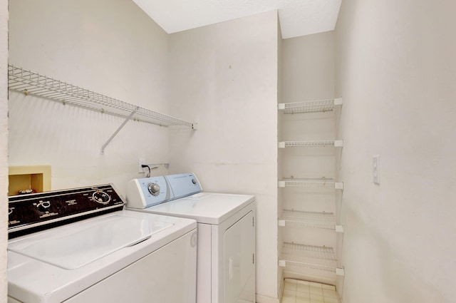 clothes washing area featuring laundry area and washer and clothes dryer