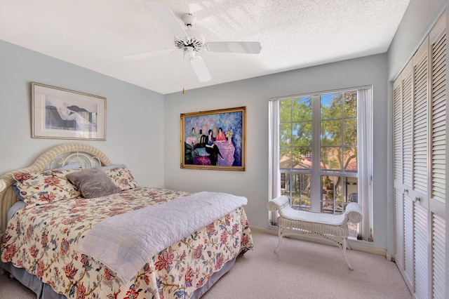 carpeted bedroom featuring a textured ceiling, ceiling fan, and a closet