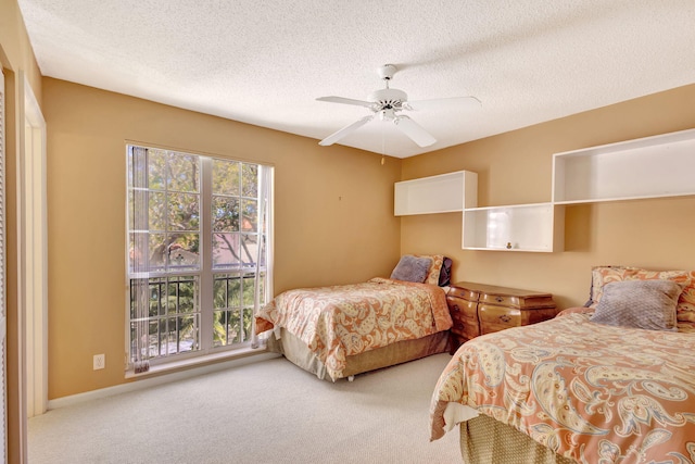 bedroom featuring a textured ceiling, multiple windows, and carpet flooring