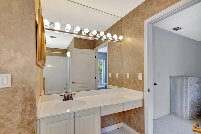 bathroom featuring a shower, vanity, and visible vents