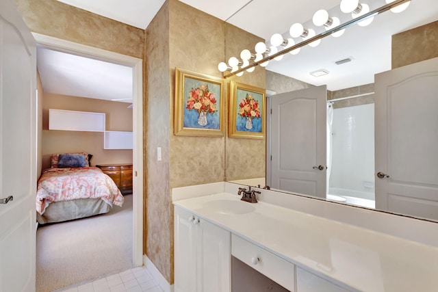 ensuite bathroom featuring visible vents, connected bathroom, and vanity