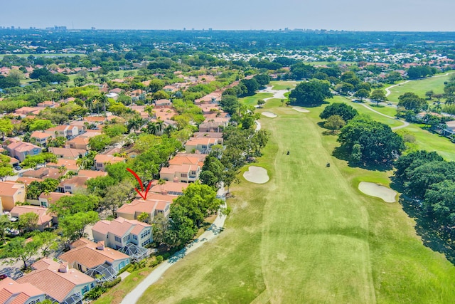 drone / aerial view featuring view of golf course and a residential view