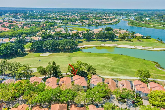 birds eye view of property featuring view of golf course, a water view, and a residential view