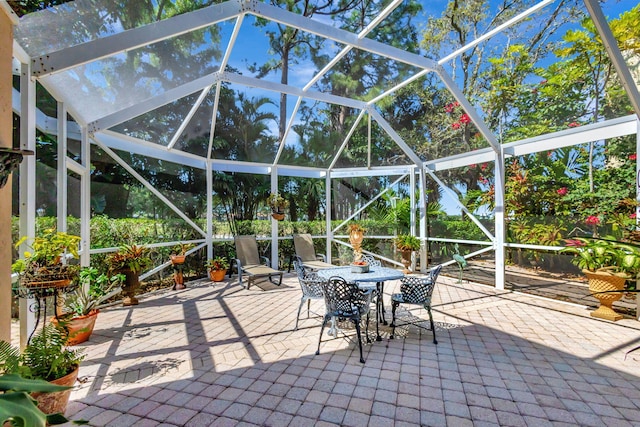 view of patio with a lanai and outdoor dining space