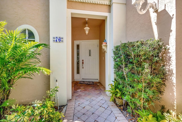 entrance to property with stucco siding