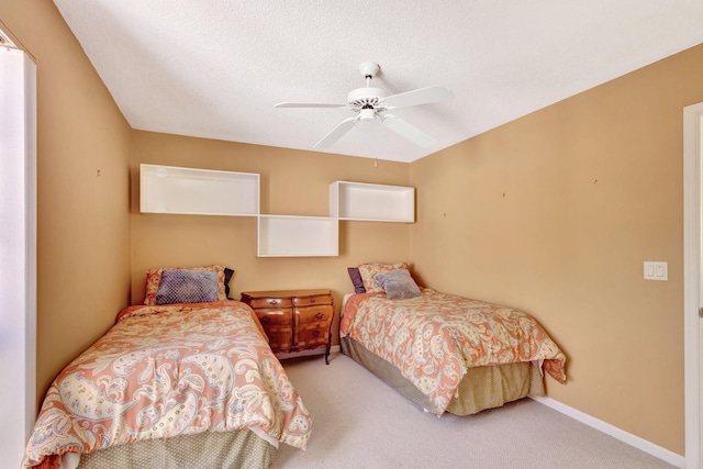 carpeted bedroom featuring ceiling fan and baseboards