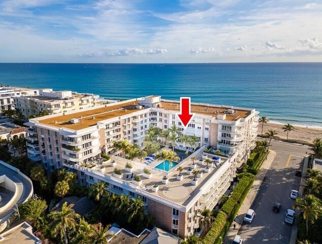 aerial view with a water view and a beach view