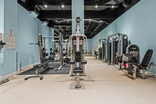 gym with baseboards and carpet flooring