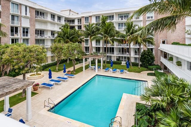 pool with a patio area and a pergola