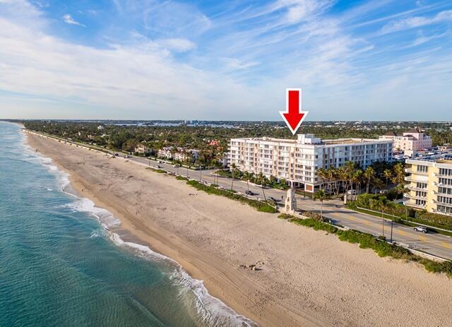 drone / aerial view featuring a view of the beach and a water view