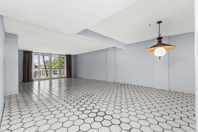 interior space featuring expansive windows and tile patterned floors