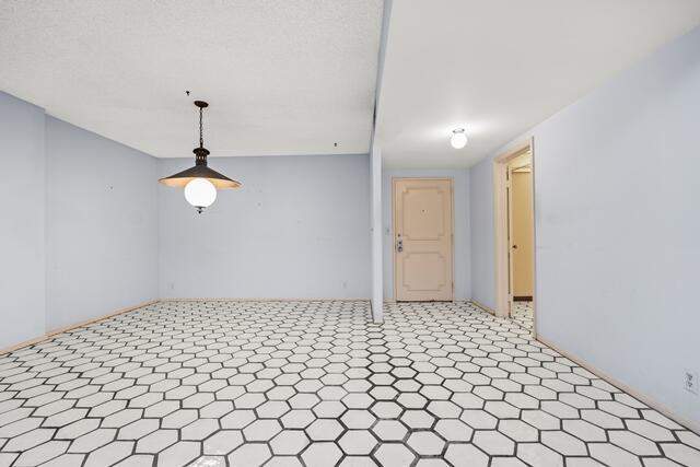 unfurnished room featuring tile patterned floors