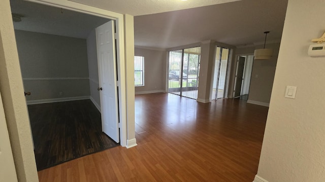 unfurnished room with wood finished floors and baseboards