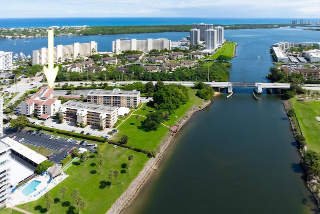 birds eye view of property with a view of city and a water view