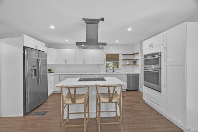 806 S 12th St, Fort Pierce, FL 34950 - kitchen featuring white cabinets, light countertops, appliances with stainless steel finishes, a center island, and open shelves