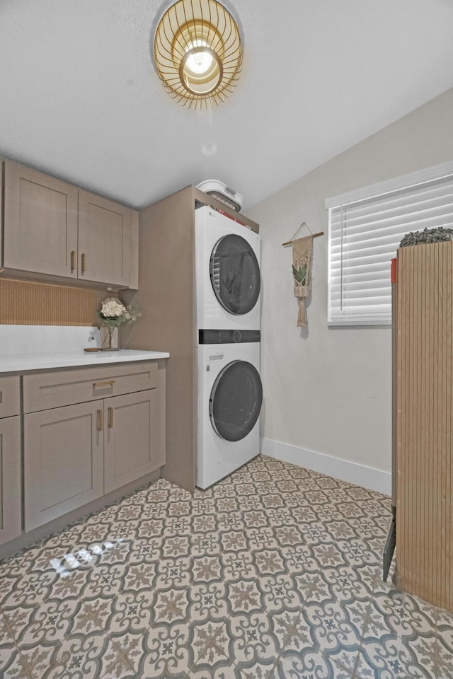 806 S 12th St, Fort Pierce, FL 34950 - laundry room featuring light floors, baseboards, cabinet space, and stacked washing maching and dryer