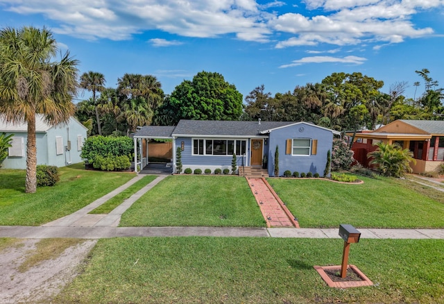 ranch-style home with an attached carport and a front lawn