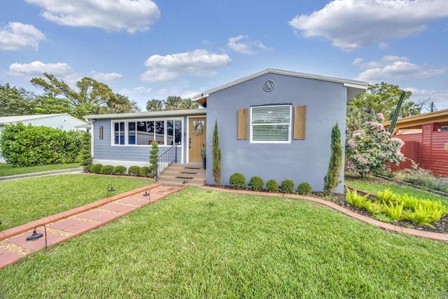 806 S 12th St, Fort Pierce, FL 34950 - view of front of house with a front yard and stucco siding