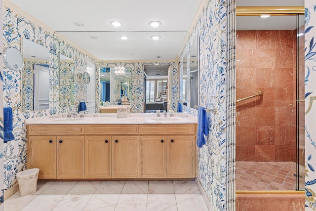 bathroom with a stall shower, wallpapered walls, and a sink