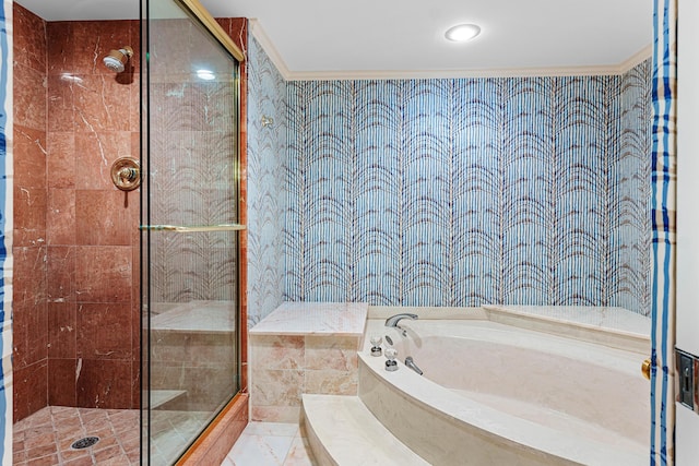 bathroom with a shower stall, a garden tub, and ornamental molding